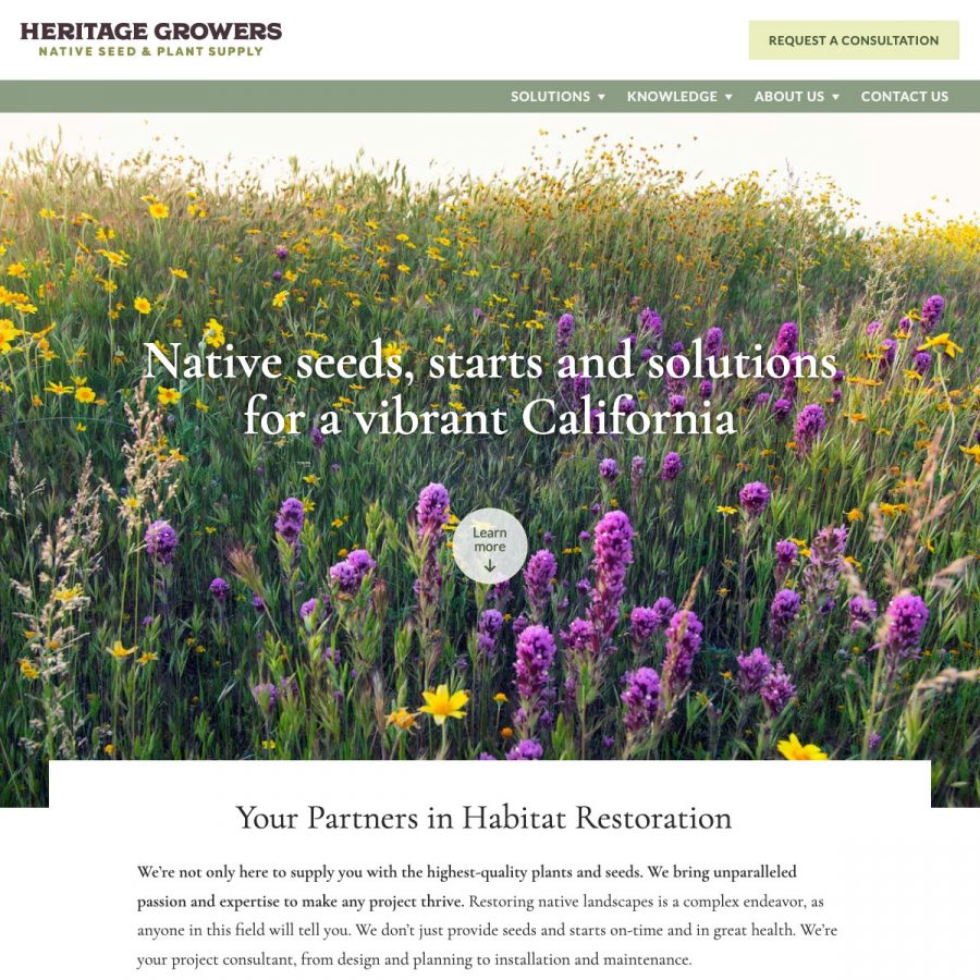 screenshot of the Heritage Growers homepage, showing a large hero image of wildflowers